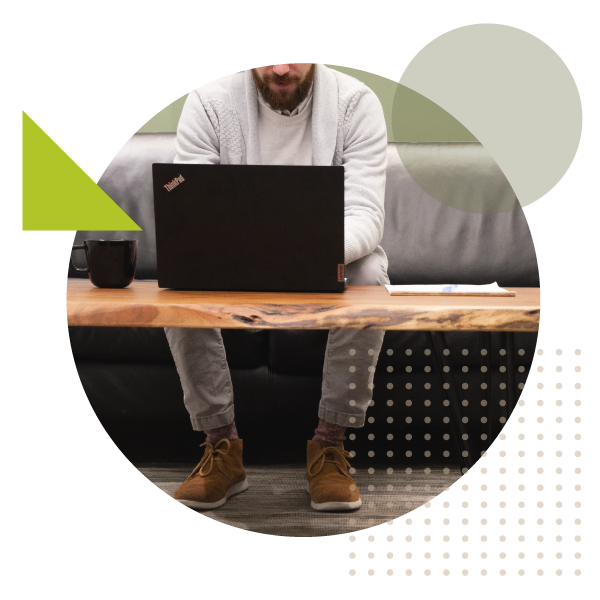 man sitting at a laptop computer